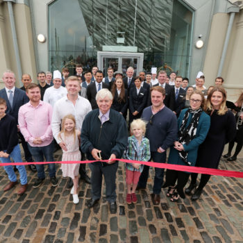 Press Release image 

Press Eye - Belfast - Northern Ireland - 10th September 2017 

Titanic Hotel Belfast has opened with fanfare in the city's Titanic Quarter where the Harland & Wolff headquarters once stood. The £28m Harcourt operated hotel tells the story of Belfast's shipbuilding and maritime history of the past 100 years. 

The Drawing Offices, where Titanic itself was designed, have been fully restored to their former glory thanks to a £5m grant from the Heritage Lottery Fund's Enterprise Fund.

With 119 suites boasting views of Harland & Wolff cranes to the east and the Titanic Slipways to the west, Titanic Hotel Belfast is a unique heritage experience adding to Belfast's booming tourist offering.

Pat Doherty of Harcourt Developments is pictured with family members and staff at the official opening this afternoon.

Photo by Kelvin Boyes / Press Eye.